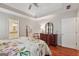 Large primary bedroom features trey ceiling, hardwood floors, dresser and attached en suite bathroom at 412 Rock Creek Dr, Peachtree City, GA 30269