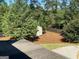 Backyard view with a shed, newly laid mulch, and manicured shrubs at 137 Nobility Ln, Mcdonough, GA 30252