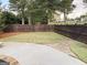 Fenced backyard with a well-maintained lawn, landscaping, and a glimpse of the home at 137 Nobility Ln, Mcdonough, GA 30252