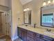 Bright bathroom featuring a double vanity with granite countertops and elegant mirrors at 137 Nobility Ln, Mcdonough, GA 30252