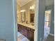 Bathroom boasts double vanity, granite countertops, and decorative mirrors at 137 Nobility Ln, Mcdonough, GA 30252
