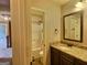 Bathroom featuring a single vanity, mirror, and toilet with shower at 137 Nobility Ln, Mcdonough, GA 30252