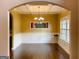 Formal dining room featuring wainscoting, dark hardwood floors, and modern chandelier at 137 Nobility Ln, Mcdonough, GA 30252