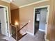 Upper hallway with carpet flooring and access to bedrooms at 137 Nobility Ln, Mcdonough, GA 30252