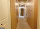 Carpeted hallway with neutral walls leading to various rooms at 137 Nobility Ln, Mcdonough, GA 30252