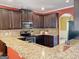 Gourmet kitchen featuring granite countertops, stainless steel appliances, and dark wood cabinetry at 137 Nobility Ln, Mcdonough, GA 30252