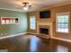 Spacious living room features a cozy brick fireplace and ample natural light at 137 Nobility Ln, Mcdonough, GA 30252