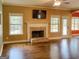 Living room with brick fireplace, dark hardwood flooring, and lots of natural light at 137 Nobility Ln, Mcdonough, GA 30252