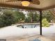 View of the backyard from the covered patio, showcasing the pool and landscaping at 137 Nobility Ln, Mcdonough, GA 30252