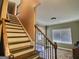 Inviting staircase leads to the upper level with a view of the foyer at 137 Nobility Ln, Mcdonough, GA 30252