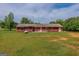 Red house has windows and doors accessing the yard, providing private exterior space and natural light at 1170 Peeksville Rd, Locust Grove, GA 30248