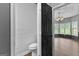 Powder room showing shiplap accent wall, toilet, and view into room with bright bay windows at 355 Sturgess Run, Sharpsburg, GA 30277