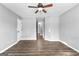 Bedroom with neutral walls, wood-look floors, and ceiling fan at 355 Sturgess Run, Sharpsburg, GA 30277