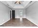 Large bedroom with wood-look floors, a ceiling fan, and windows allowing plenty of natural light at 355 Sturgess Run, Sharpsburg, GA 30277