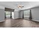 Bedroom with wood-look floors, accent wall, and a ceiling fan at 355 Sturgess Run, Sharpsburg, GA 30277