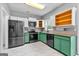 Bright kitchen with stainless steel appliances, unique two-tone cabinets, and modern tile flooring at 355 Sturgess Run, Sharpsburg, GA 30277