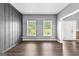 Bright living room with wood-look floors, two windows, gray walls, and open access to other rooms at 355 Sturgess Run, Sharpsburg, GA 30277