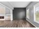 Spacious living room with a fireplace, wood-look flooring, natural light, and modern gray walls at 355 Sturgess Run, Sharpsburg, GA 30277