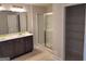 Modern bathroom with a glass-enclosed shower, double vanity, and ample shelving at 13 Butternut Way # 120B, Auburn, GA 30011