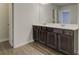 Elegant bathroom with double sink vanity, dark wood cabinetry, and ample counter space for convenience at 13 Butternut Way # 120B, Auburn, GA 30011