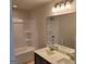 Bright bathroom with a bathtub-shower combination and a vanity with double sinks at 13 Butternut Way # 120B, Auburn, GA 30011