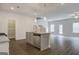 Open-concept kitchen with granite countertops and stainless steel appliances at 13 Butternut Way # 120B, Auburn, GA 30011