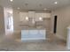 Unfinished kitchen with white cabinets, a center island, and modern pendant lighting at 13 Butternut Way # 120B, Auburn, GA 30011