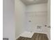 Bright laundry room with new floors, a utility sink, and washer/dryer hookups at 13 Butternut Way # 120B, Auburn, GA 30011