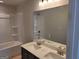 Bathroom featuring double sink vanity, large mirror, and tub shower combination at 42 Avian Way # 128B, Auburn, GA 30011