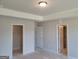 Empty bedroom featuring neutral paint, a closet, and a door leading to the ensuite bathroom at 42 Avian Way # 128B, Auburn, GA 30011