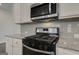 Modern kitchen features stainless steel appliances, granite countertops, and white cabinets at 42 Avian Way # 128B, Auburn, GA 30011