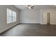 Living Room with hardwood floors, ceiling fan and large window at 42 Avian Way # 128B, Auburn, GA 30011