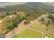 An expansive aerial view of the property, showcasing its vast acreage, access to the road and surrounded forest at 99 Landers Ne Rd, Rydal, GA 30171