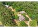 Aerial view of a large, secluded estate with a house, barn, and surrounded by mature trees at 99 Landers Ne Rd, Rydal, GA 30171