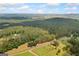 Panoramic aerial view highlighting the property's vastness, road access, and its wooded seclusion at 99 Landers Ne Rd, Rydal, GA 30171