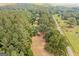 Extensive aerial view of the property with road access and surrounded by dense trees, creating a private setting at 99 Landers Ne Rd, Rydal, GA 30171