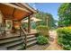 Inviting outdoor space featuring a covered deck with comfortable seating and beautiful landscaping at 99 Landers Ne Rd, Rydal, GA 30171