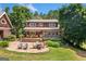 Beautiful backyard featuring a deck, patio with seating, lush greenery, and mature trees at 99 Landers Ne Rd, Rydal, GA 30171