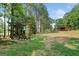 A backyard swing set and rustic barn complement the landscape at 99 Landers Ne Rd, Rydal, GA 30171