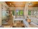 This primary bathroom has a glass enclosed shower, soaking tub and unique fixtures and finishes at 99 Landers Ne Rd, Rydal, GA 30171