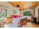 Bedroom with wood ceiling, decorative wheel, and windows with natural light at 99 Landers Ne Rd, Rydal, GA 30171