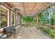 Charming deck with a wood pergola, seating area, and views of the serene surroundings at 99 Landers Ne Rd, Rydal, GA 30171