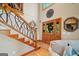 Inviting foyer featuring a unique branch railing staircase, hardwood floors, and a decorative front door at 99 Landers Ne Rd, Rydal, GA 30171
