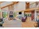 Bright living room with soaring ceilings, wood beams, stone fireplace, and an open floor plan at 99 Landers Ne Rd, Rydal, GA 30171