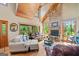 Inviting living room with a wood-burning stone fireplace and lots of natural light at 99 Landers Ne Rd, Rydal, GA 30171