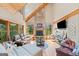 Sun-filled living area boasting a striking stone fireplace, wood accents, and large windows overlooking the lush outdoors at 99 Landers Ne Rd, Rydal, GA 30171