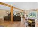 Expansive living room featuring exposed beam architecture and an open floor plan at 99 Landers Ne Rd, Rydal, GA 30171