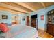 Spacious main bedroom with wood floors, beamed ceilings and access to bathroom at 99 Landers Ne Rd, Rydal, GA 30171