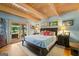 Light-filled main bedroom offers outside views, wood floors and beamed ceilings at 99 Landers Ne Rd, Rydal, GA 30171