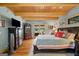 Spacious main bedroom boasts wood floors, beamed ceiling and patio access to outdoors at 99 Landers Ne Rd, Rydal, GA 30171